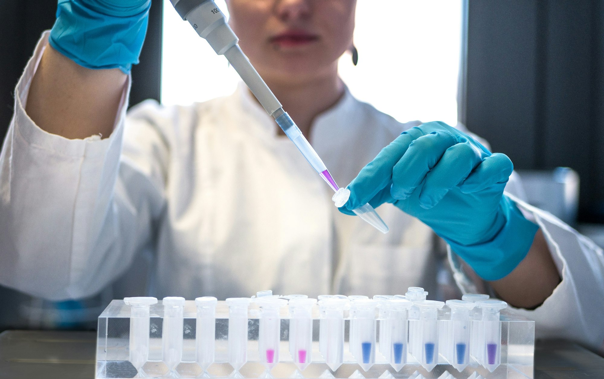Clinician pipetting samples in a laboratory